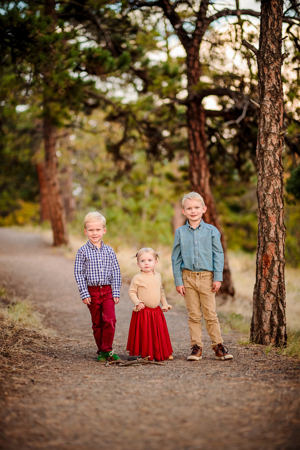 3 small children walking on a trail in the mountains